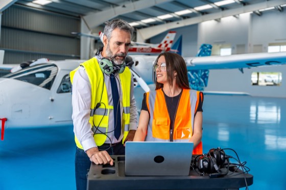 Instructor and trainee working on aircraft systems
