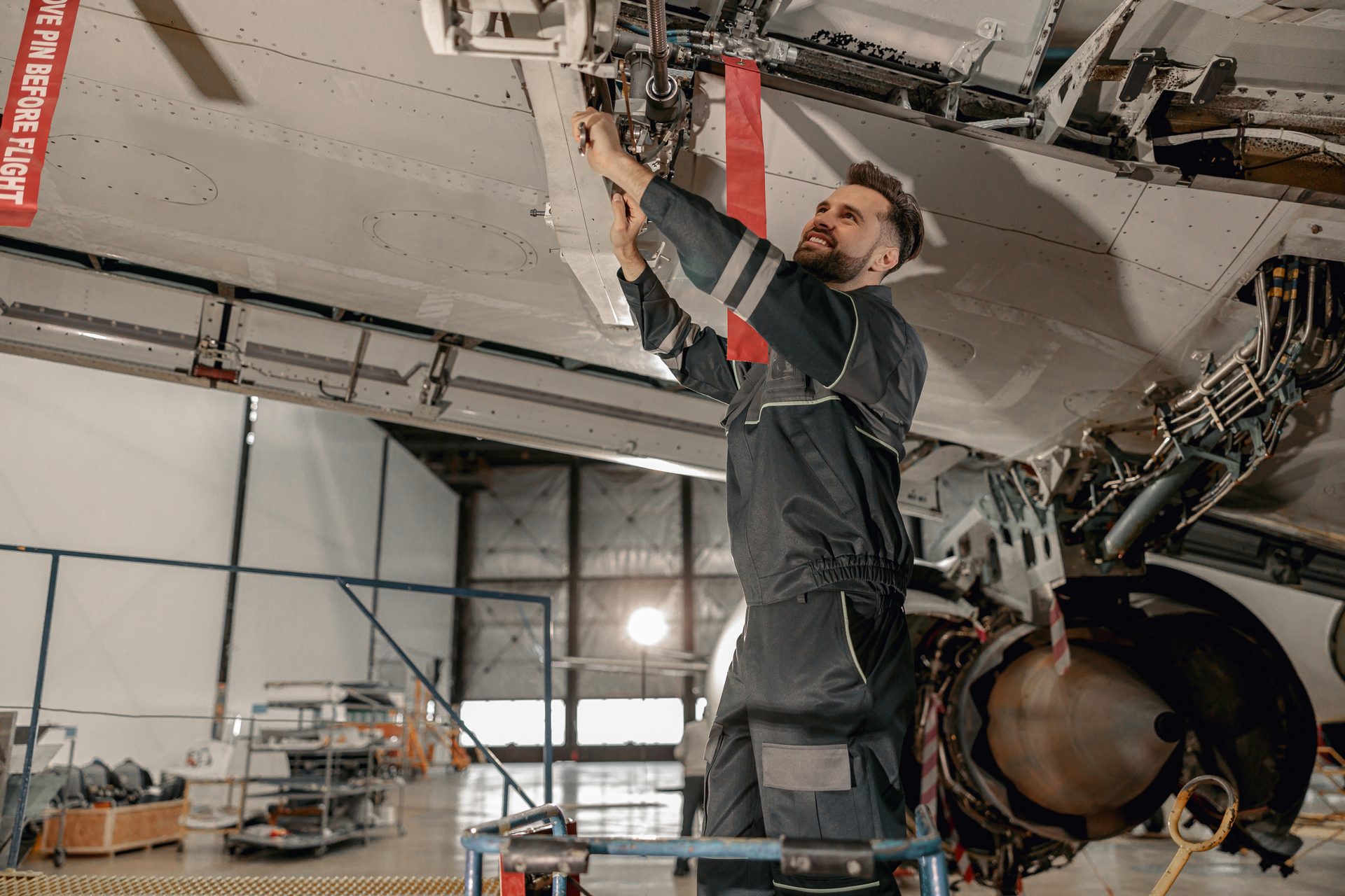 Engineer working under an aircraft in the hangar